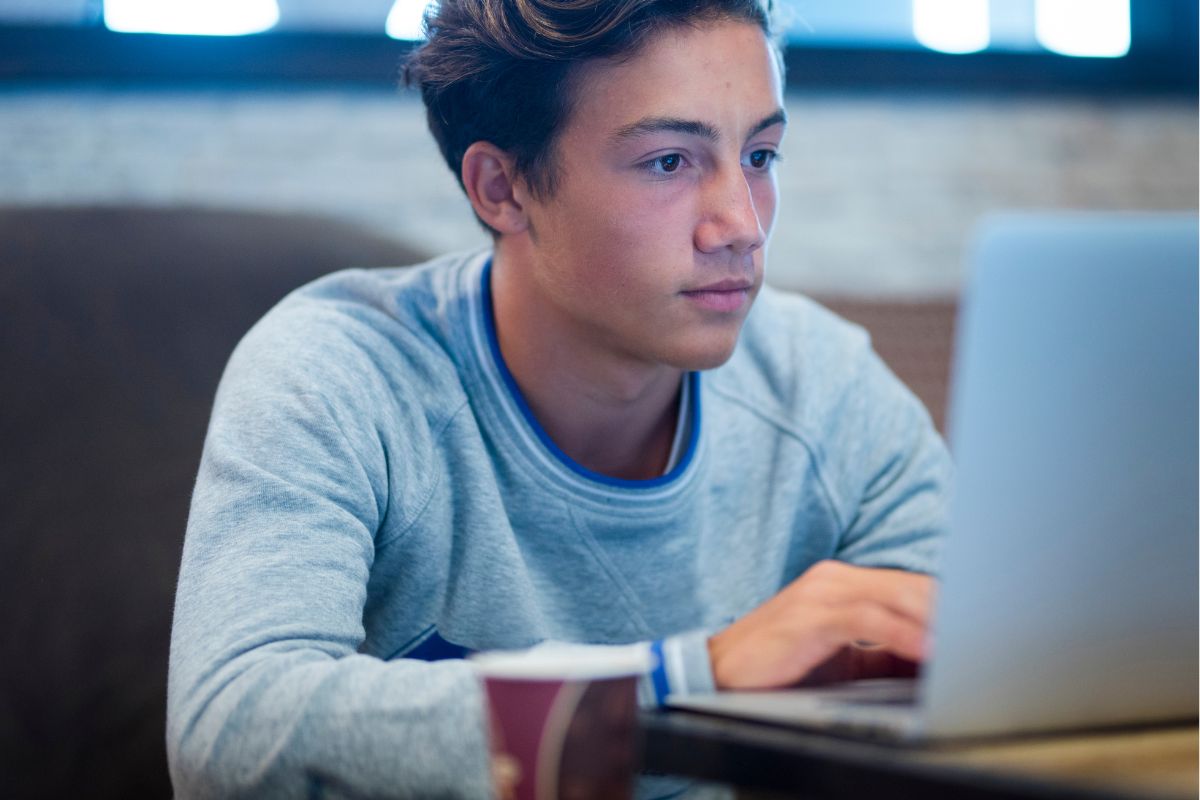 A young man using a laptop.