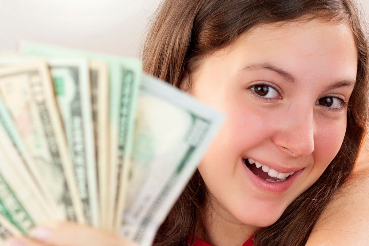 A young lady holding money.