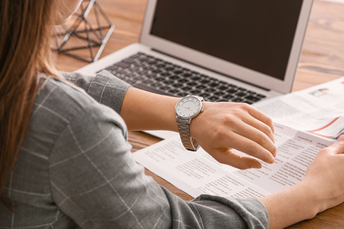Image of a woman checking the time.