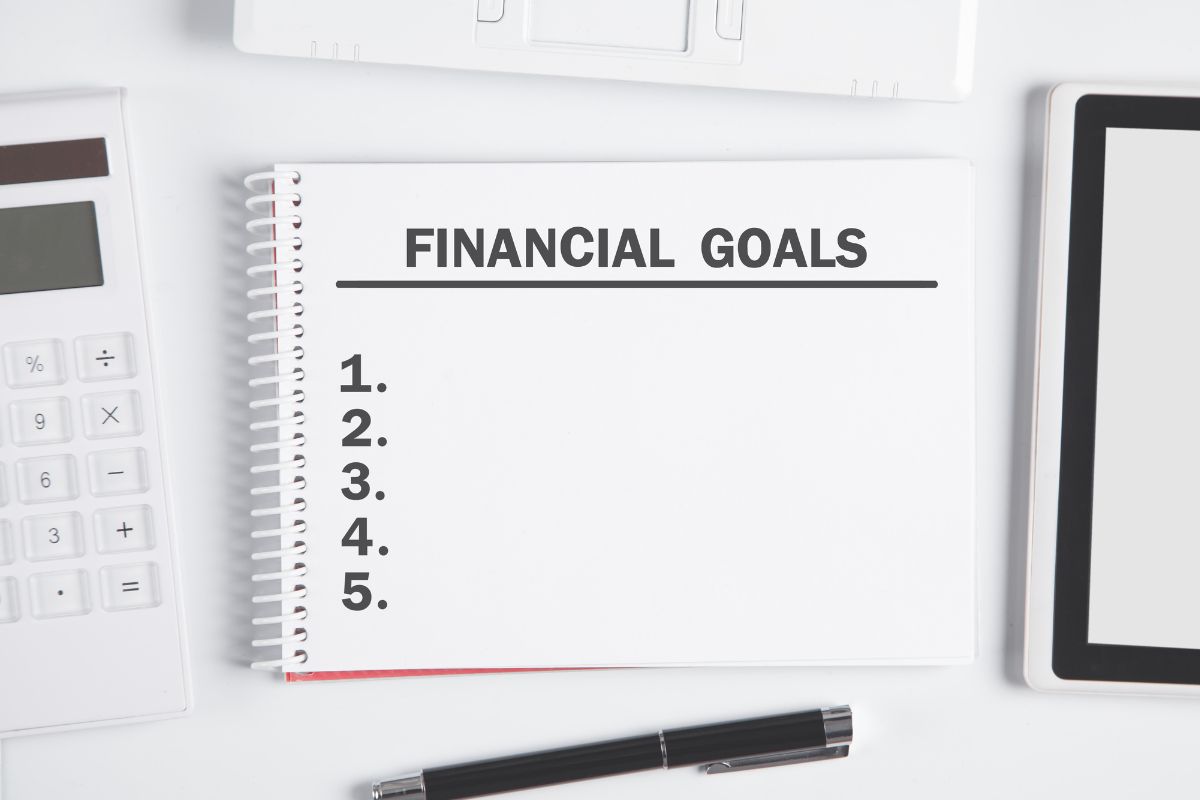 Photo of a notebook with financial goals wording.