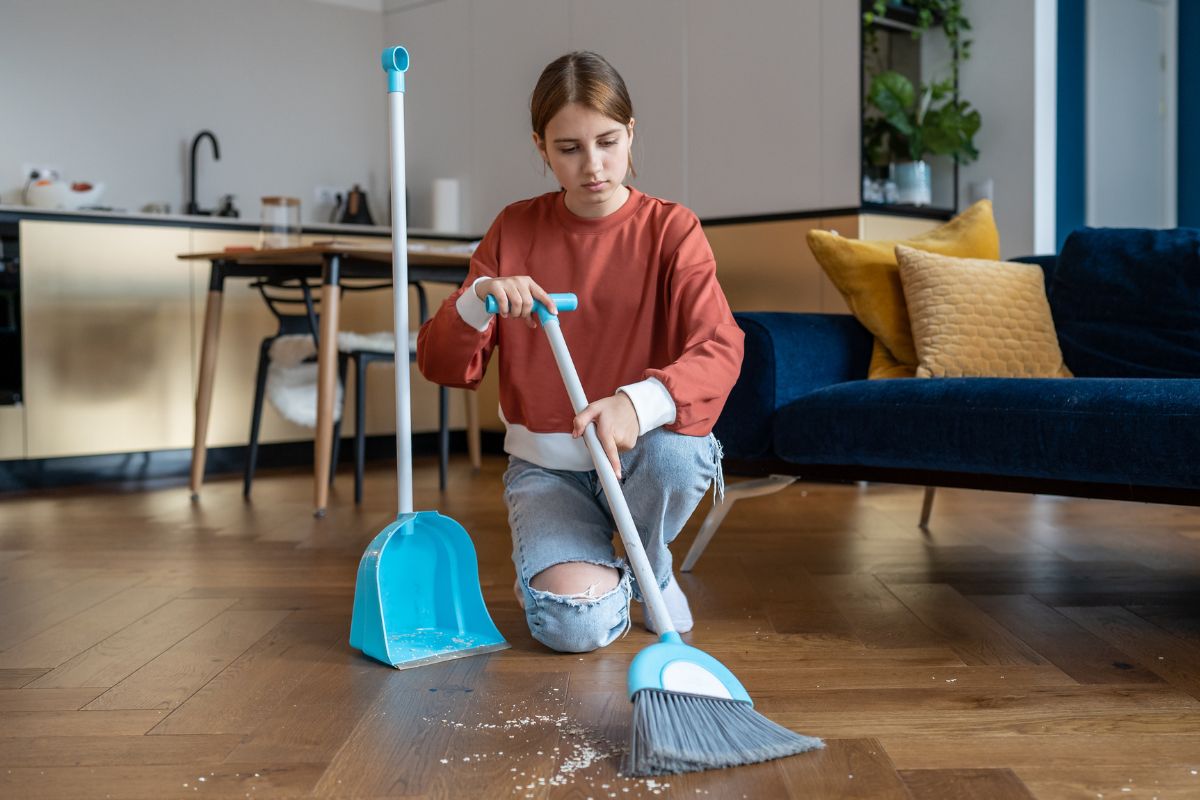 A young lady cleaning the house.