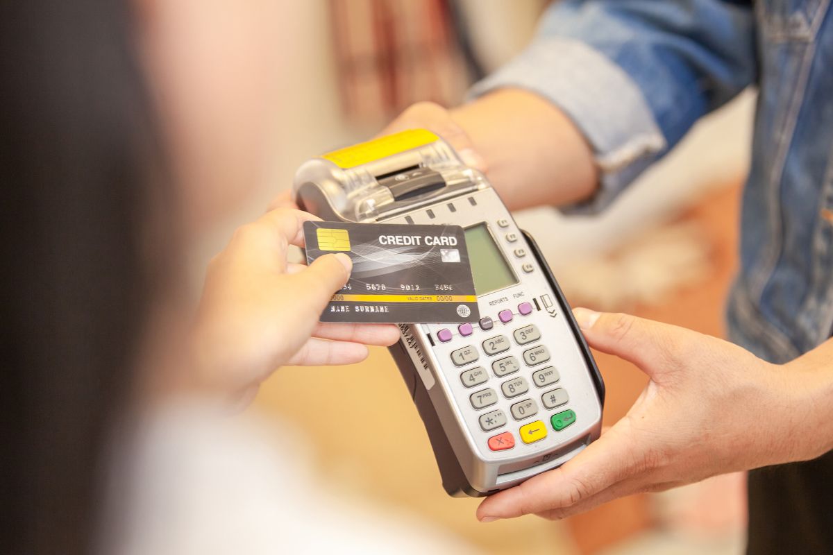 Image of a woman paying with a credit card.