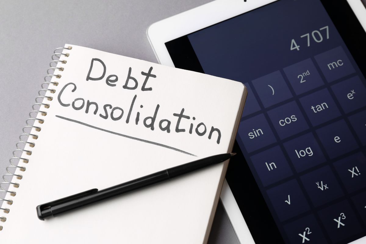 Picture of a notebook with debt consolidation wording.