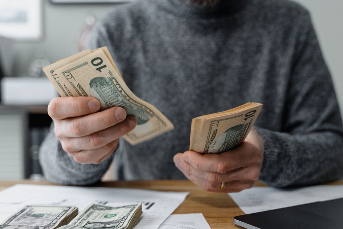 Photo of a man counting money.