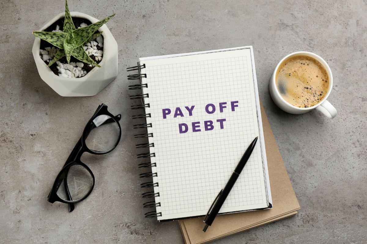 A notebook with pay-off debt wording.