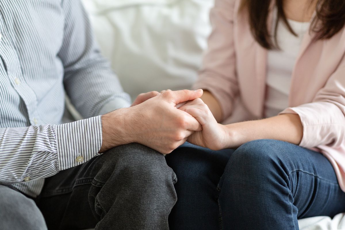 Image of a couple holding hands.