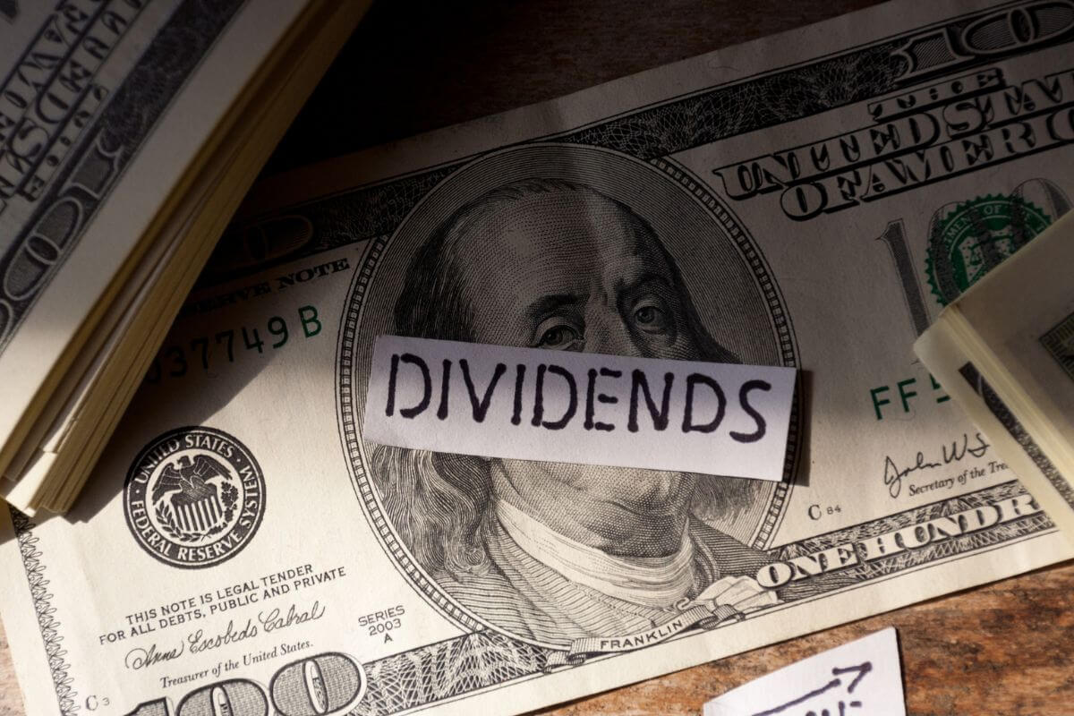 Photo of money and dividend wording.