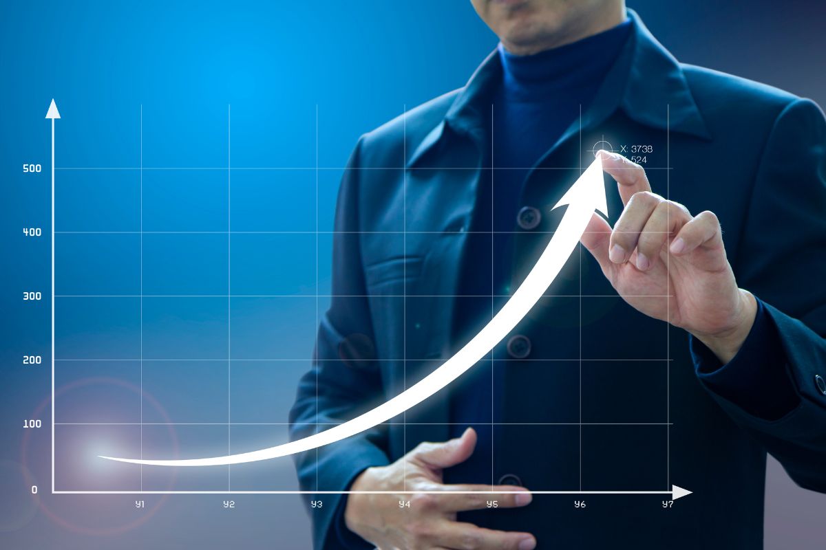 Photo of a man showing a graph.