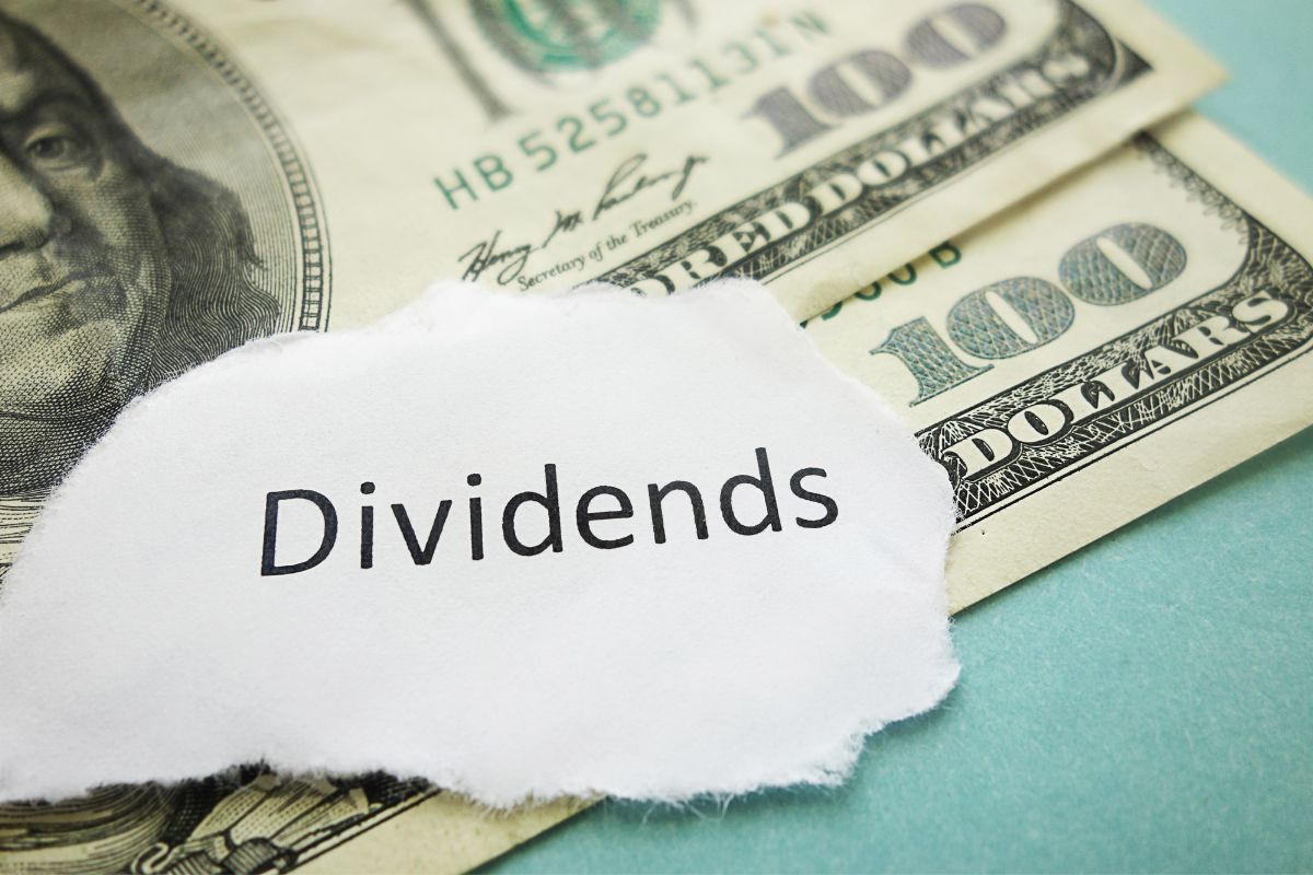The photo shows money and a dividends wording.