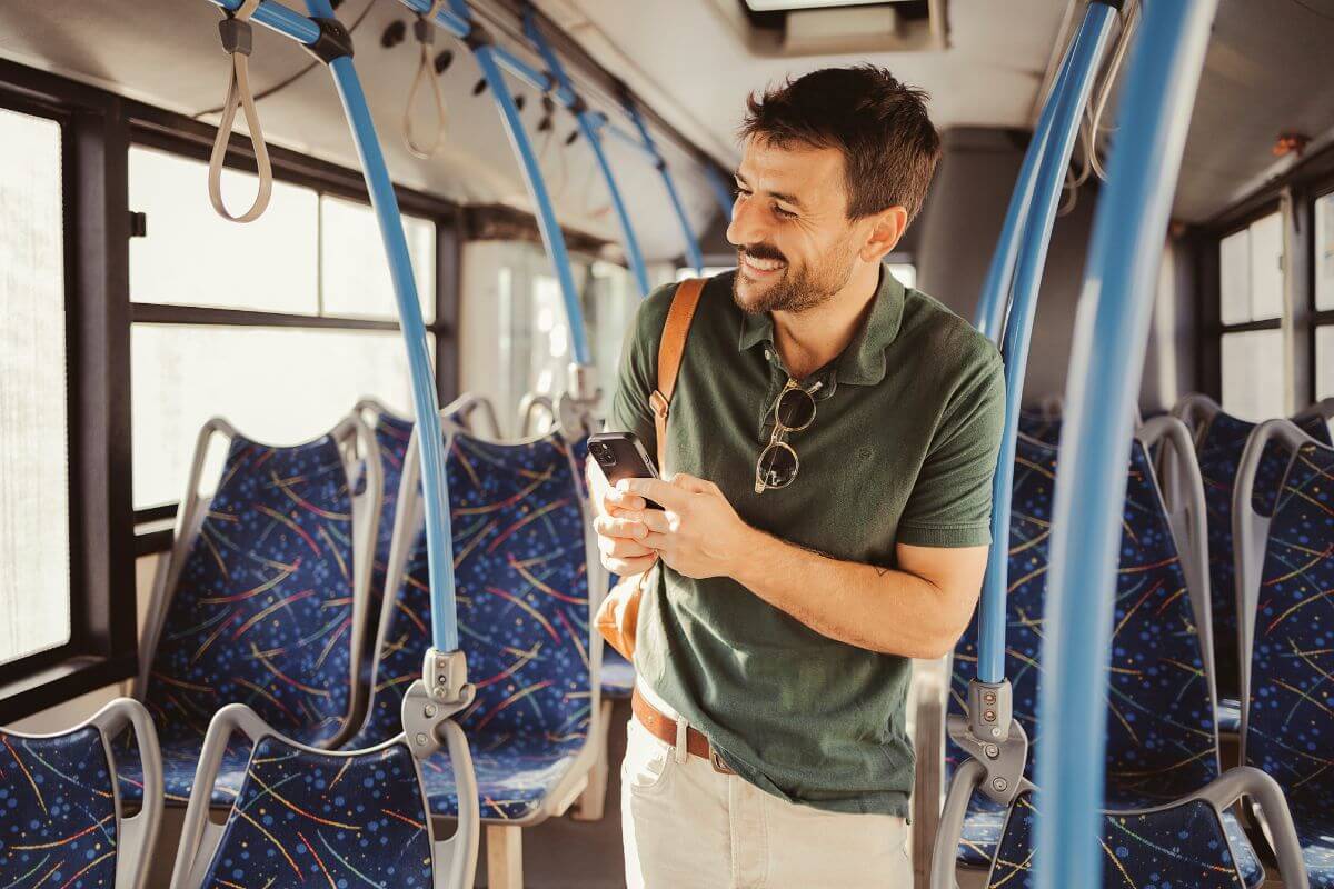 The photo shows a man using public transportation like a bus and help cut down on gas and save thousands each year while reducing your carbon footprint.