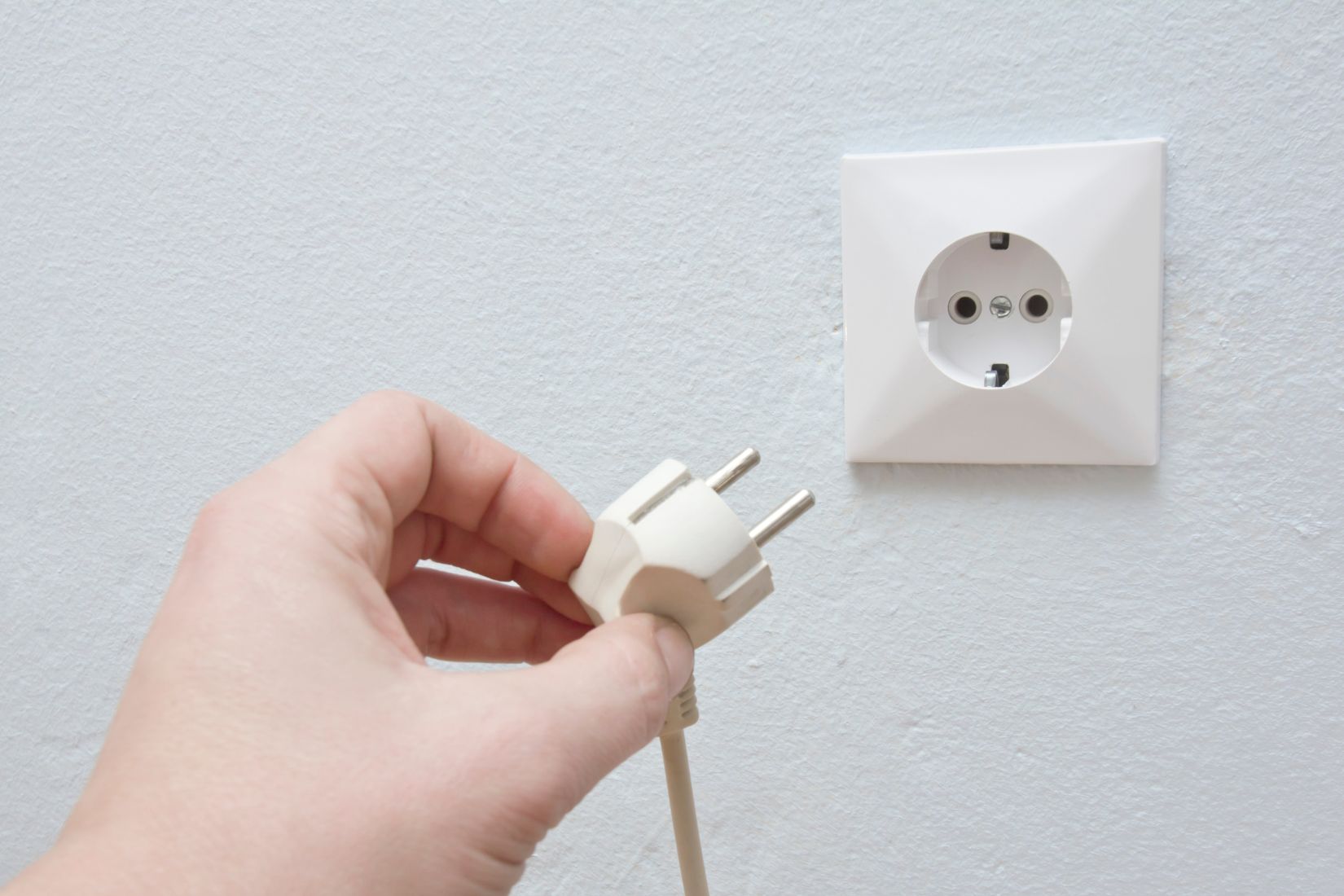 A woman's hand unplugged a cable power.