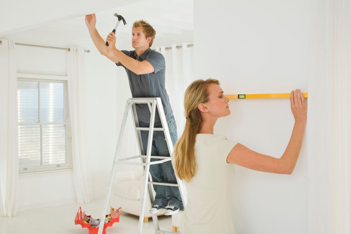 A couple repairing their home.