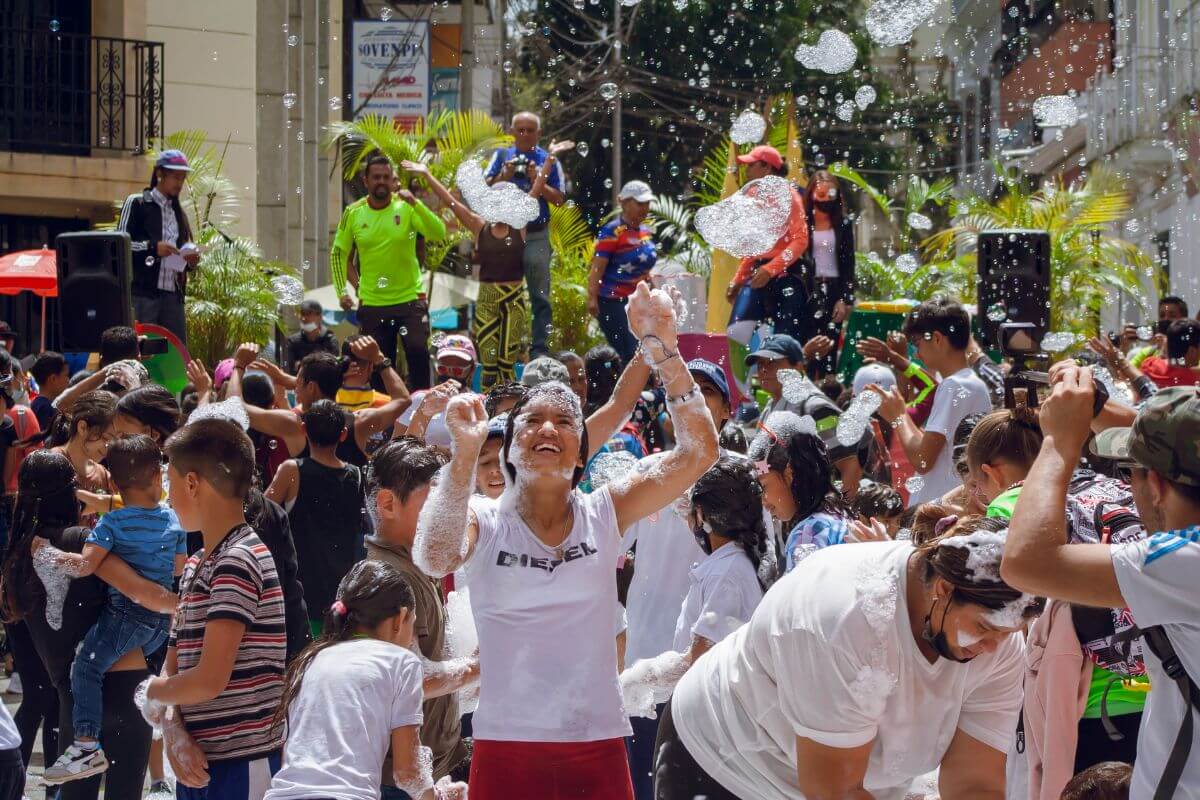The picture shows a group of people enjoying together at the public field which means taking advantage of free events and enjoying life without spending a fortune.
