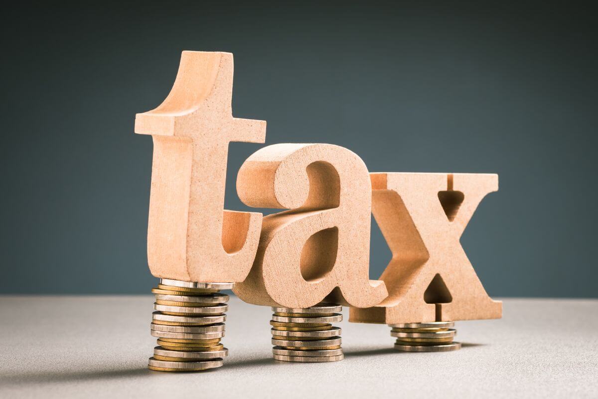 The picture shows coins stock with wooden letters at the top referring to a plan for tax efficiency to make tax season smoother and help you keep more of what you earn.