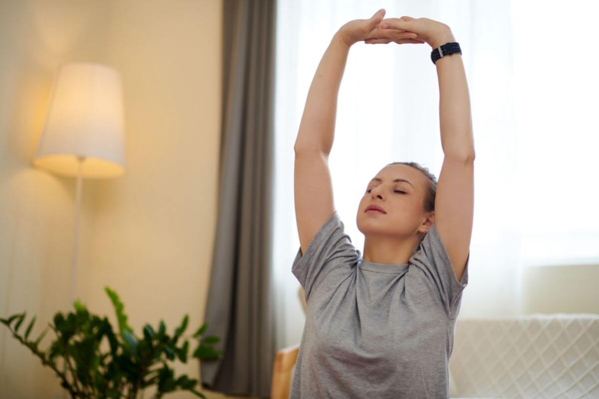 The image shows a girl lifting both hands and relaxing which refers to practicing mindfulness to reduce stress and help calm your mind so you can think clearly about your next steps.