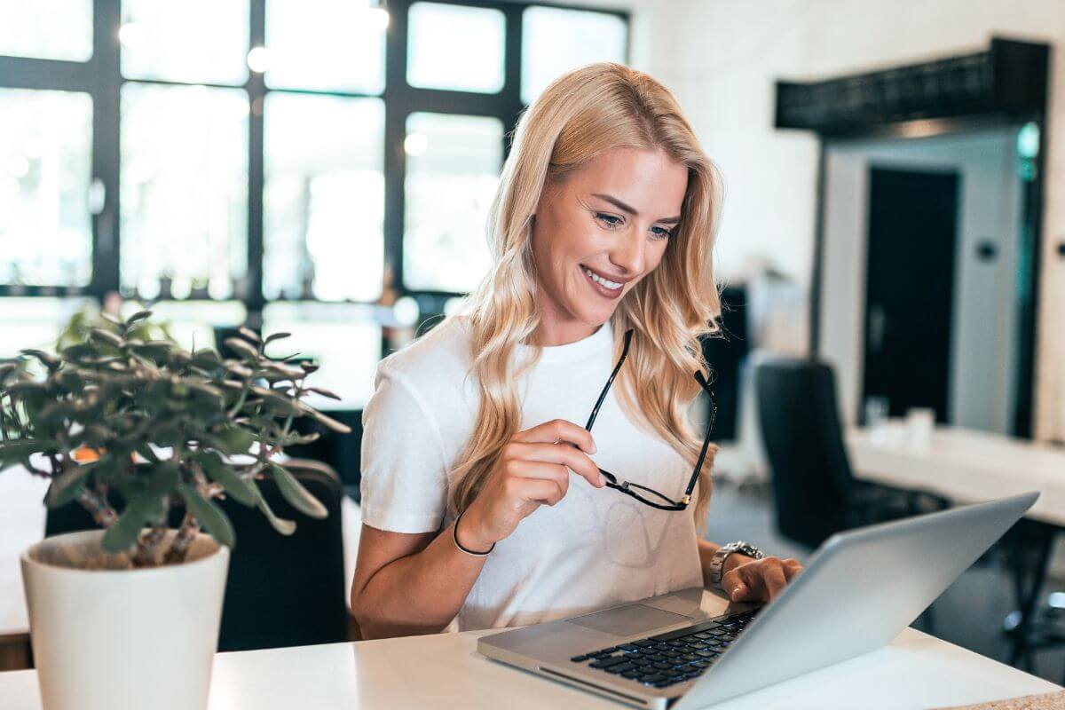 The picture of a plant and a girl holding an eyeglass and using a laptop indicates tracking sending only with apps that simplify the process by doing the hard work for you.