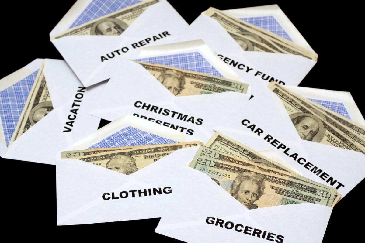 The image tells about envelopes with dollar bills and notes referring to the use of cash envelopes for discretionary spending to ensure extra money is available for debt payments.