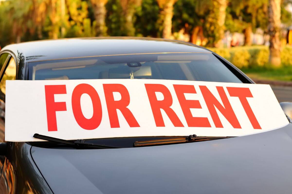 The image tells about a car with signage which means to rent out your car to make extra cash without a lot of effort.
