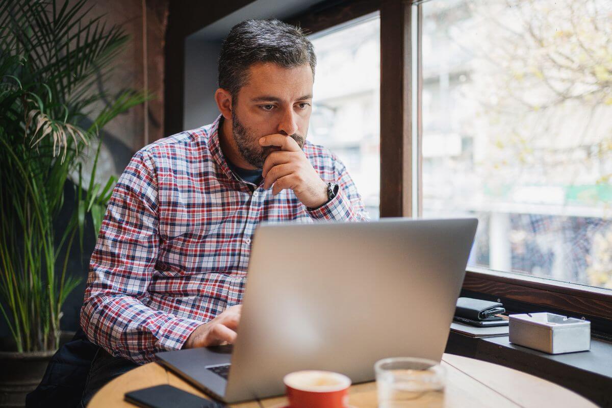 The photo tells about a man checking his laptop to cancel an unused subscription and membership to put money back in your pocket for things that matter.