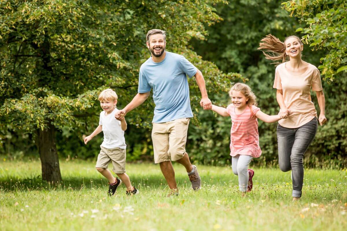 The image of a group of the family enjoying the park together indicating to take advantage of free entertainment and activities to save money and budget in check.