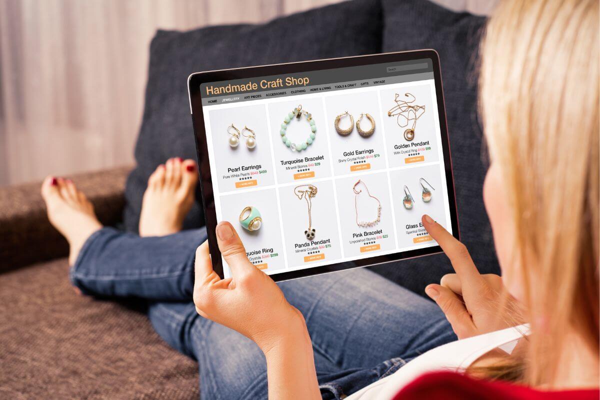 The photo tells about a girl sitting on the couch and using a tablet device to order online which means avoiding lifestyle inflation by keeping expenses low and living below your means helps create lasting financial freedom.