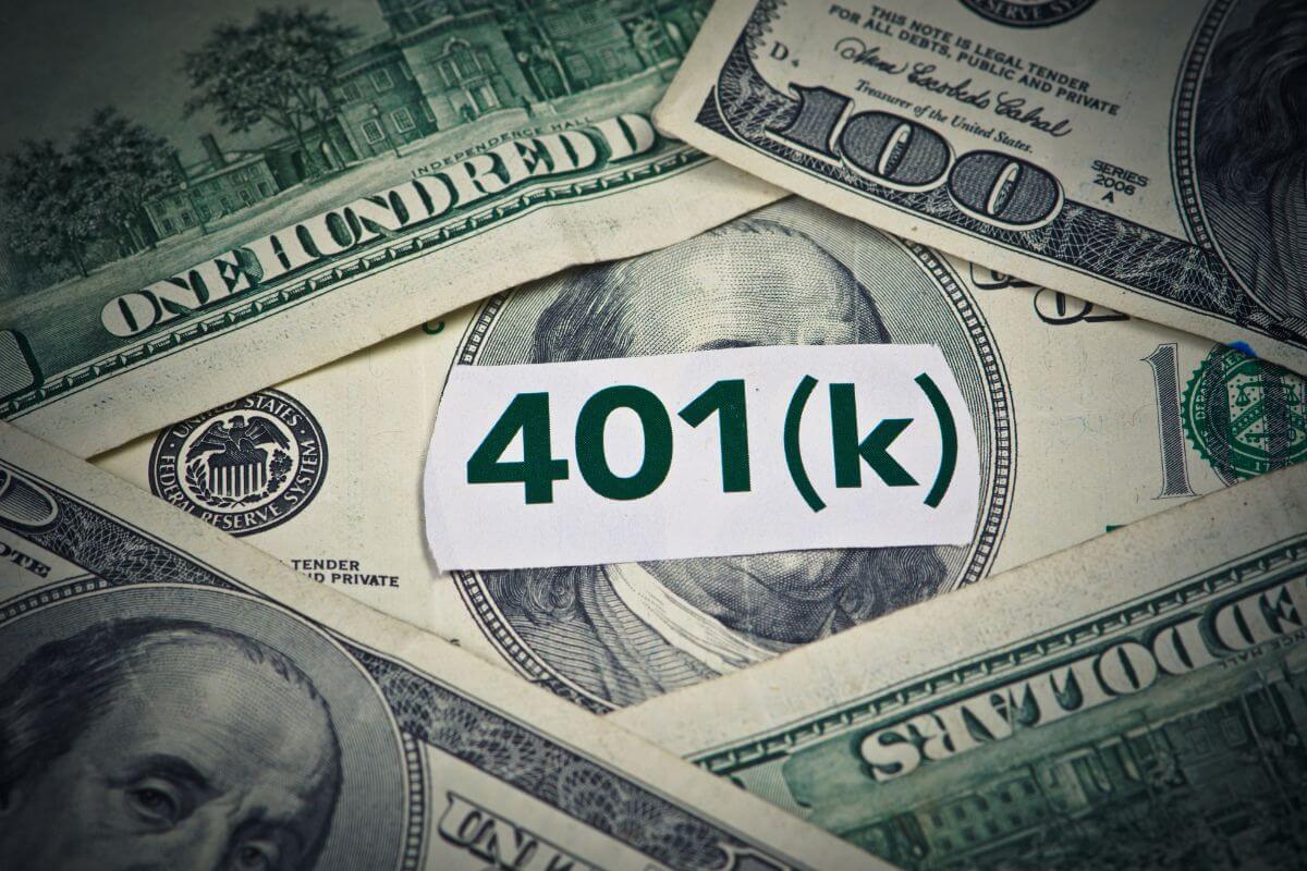 The photo tells about dollar bills and a piece of paper with a note referring to start by contributing enough to get an employer 401(k) match to grow your retirement savings.