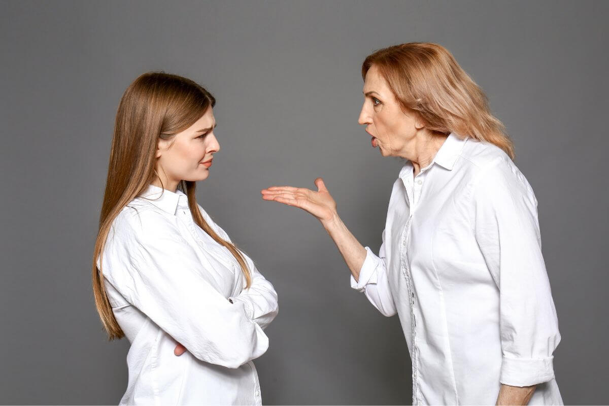 The image shows a frustrated mother scolding her daughter indicating to borrowing money can strain personal relationships and making it hard to maintain a strong bond with family.