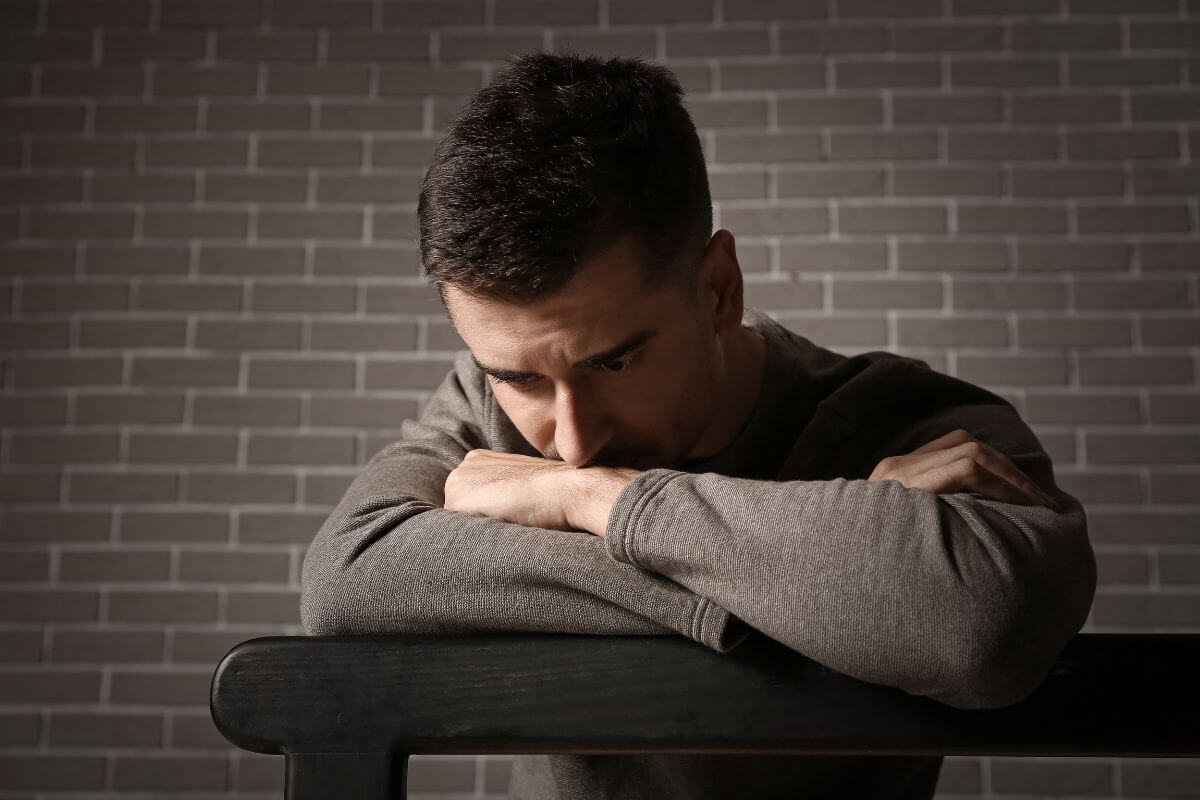 The image tells about a man having a deep thoughts reflecting to borrowing money from loved ones creates feelings of guilt or obligation which can complicate relationships and personal bounderies.