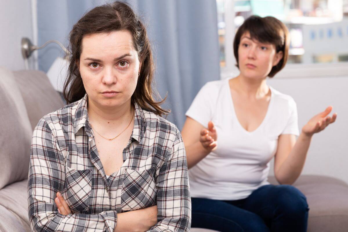 The photo shows two girls having a quarrel indicating that borrowing money can lead to resentment if repayment is delayed or forgotten which can leave the lender feeling unappreciated and the borrower feeling judged.