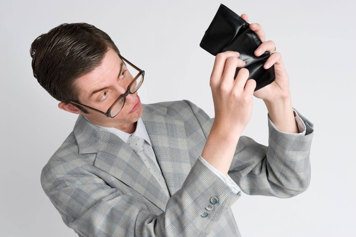 The image tells about a man opening his empty wallet which means to stop saying I am broke and focus on building good money practices to achieve financial freedom.