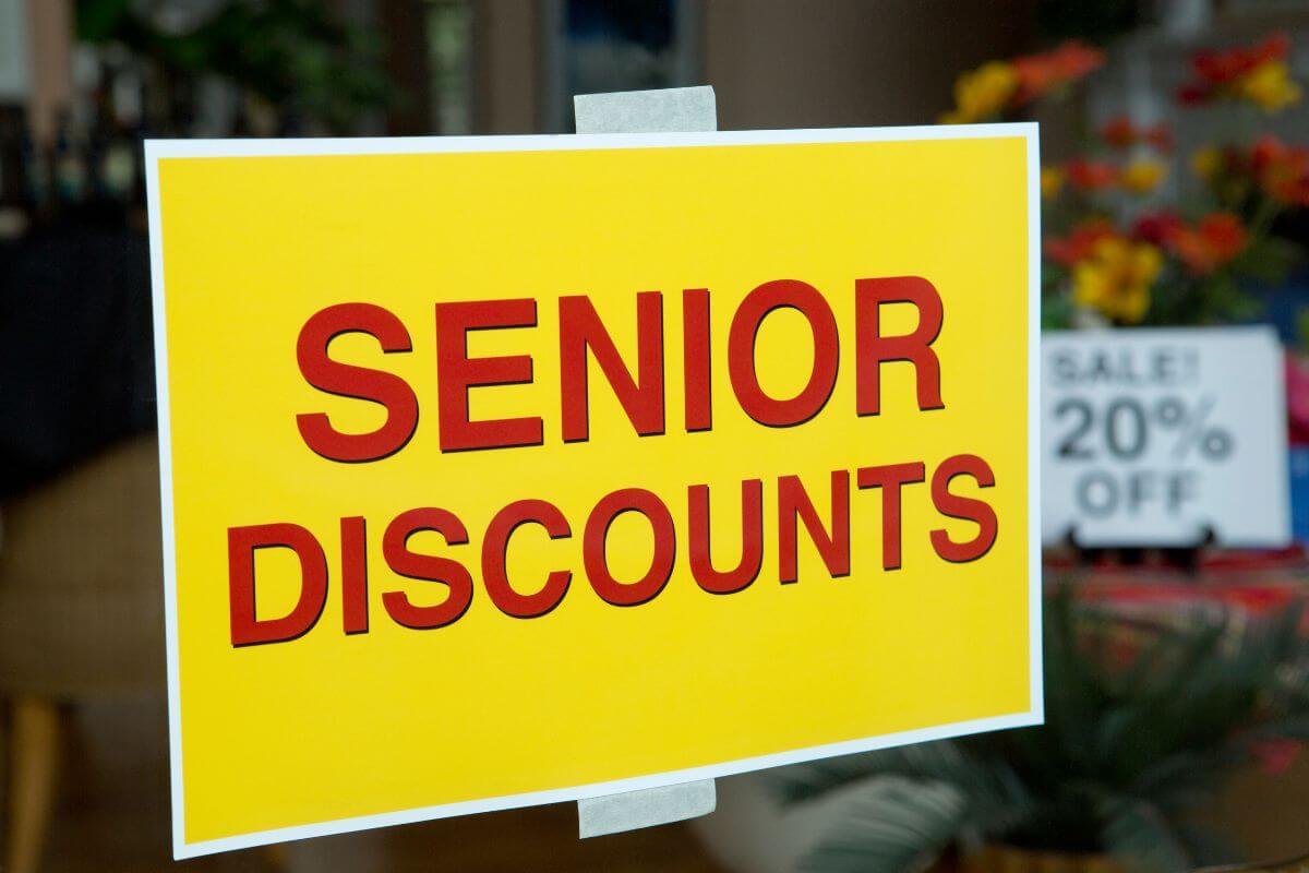 The photo tells about a yellow paper with notes taped on the glass and a white paper also with notes indicating to use senior discounts at restaurants and cafes to stretch your dining budget.