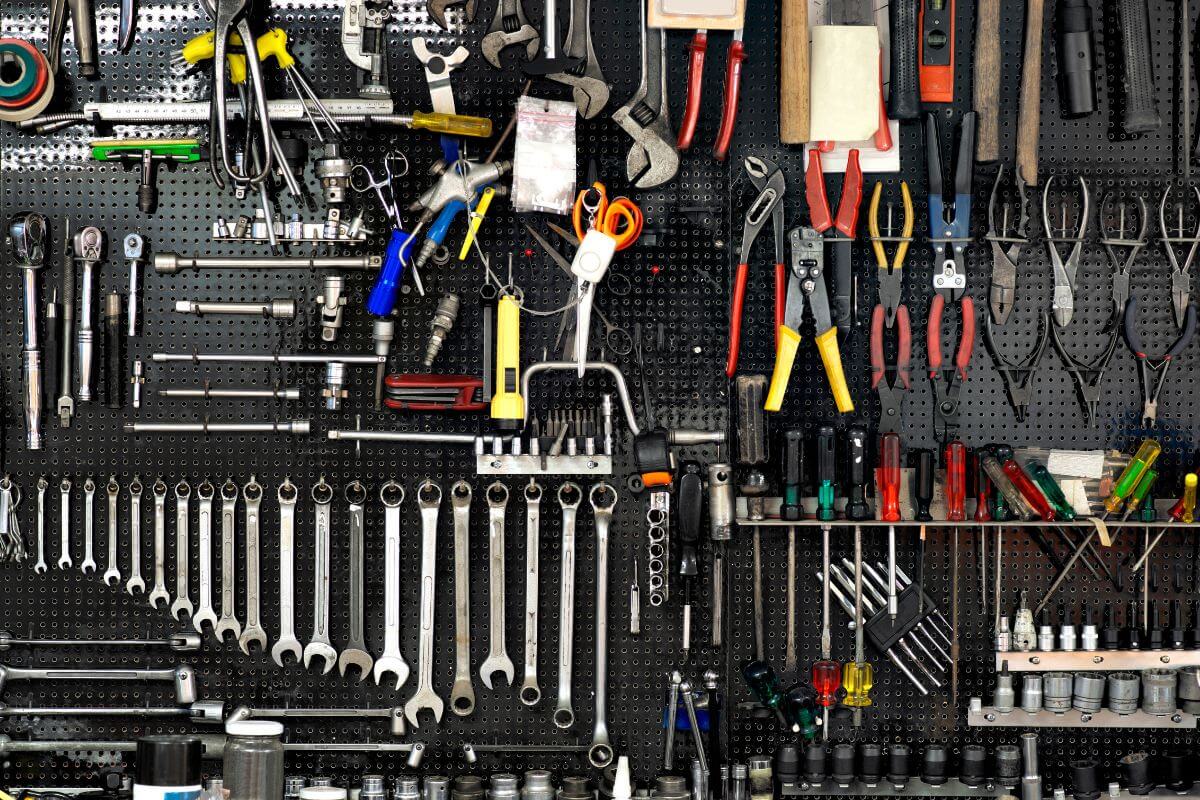 The picture shows different types of tools hanged on the wall which means to rent out equipment or tools is an easy way to make extra cash with items you already own. 