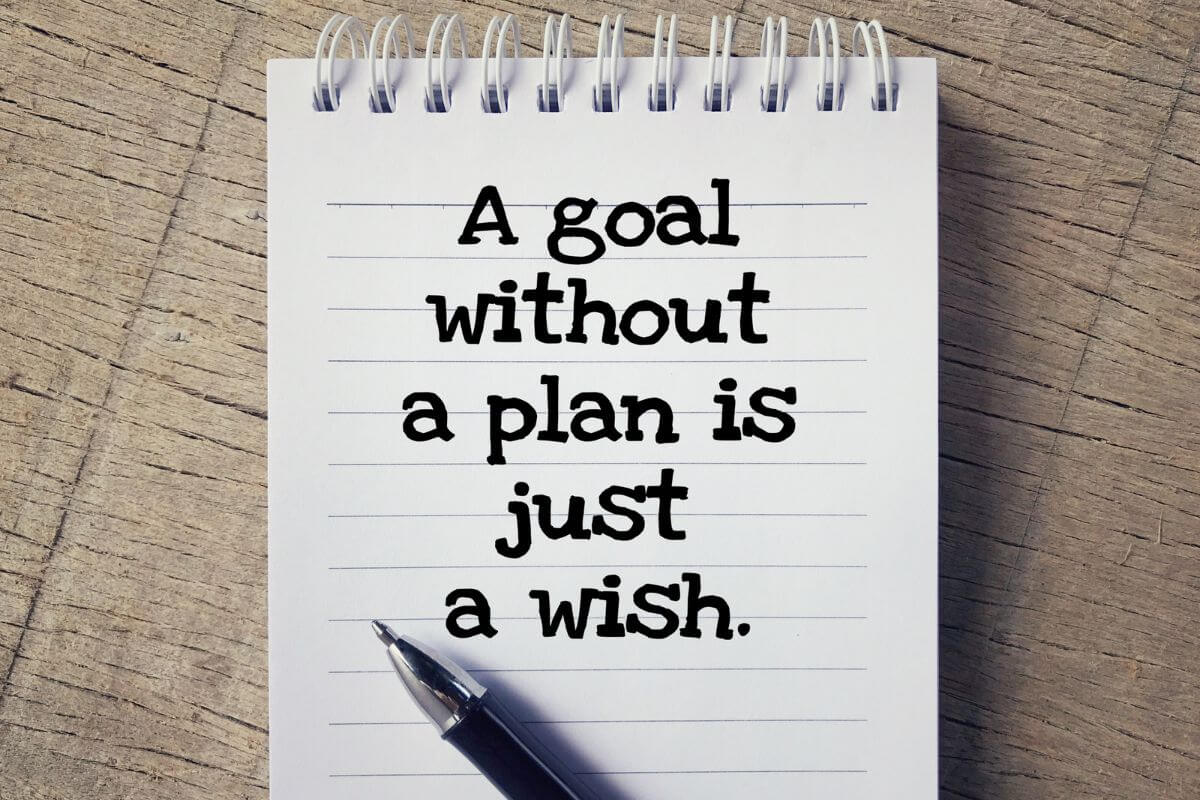 The image shows a pen and a notebook with notes which refers to reciting these money affirmations can be a powerful tool for staying disciplined.