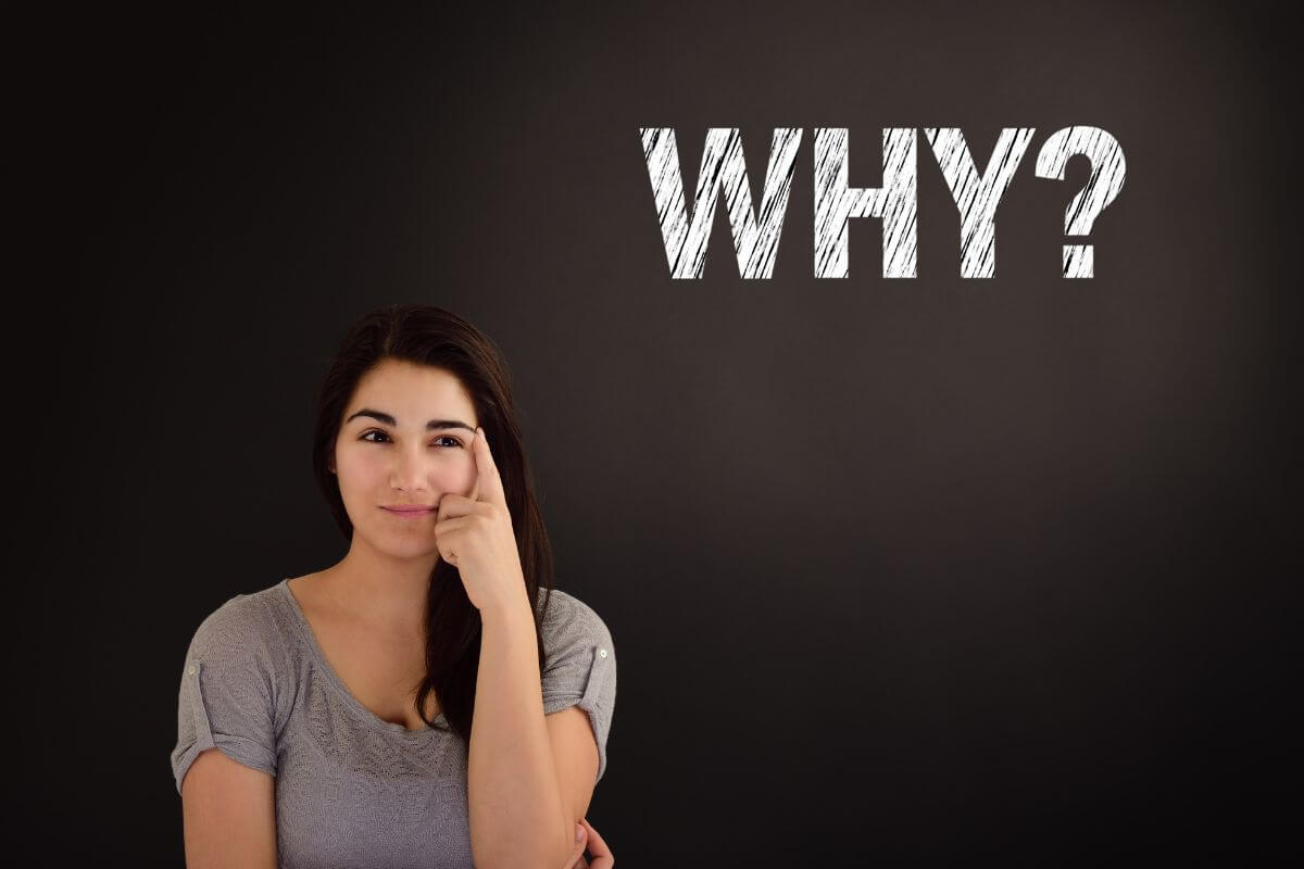 The photo shows a blackboard with a note and a girl thinking which refers to remembering your why and helps you push through challenges and stay committed.