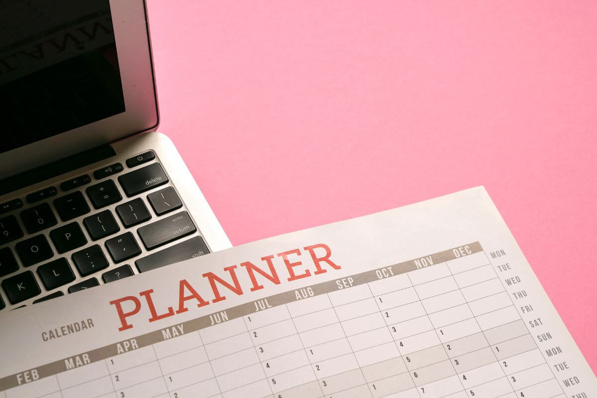 The picture tells about a laptop and a calendar indicating to provide virtual event planning services and make money while helping others host successful events.