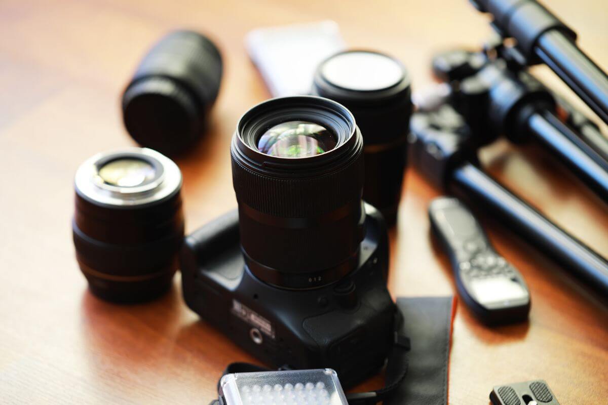 The image shows a camera, lenses, lights, remotes, and more referring to renting out photography equipment to make quick cash with items you already have. 