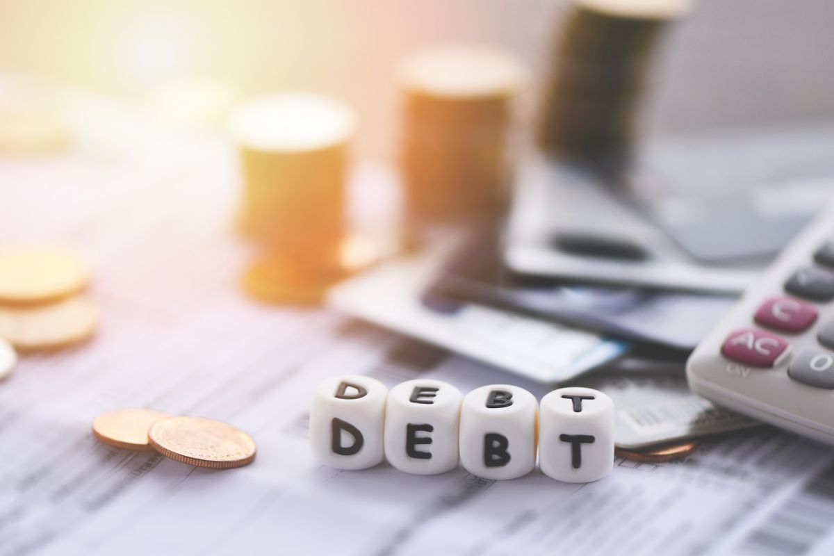 Photo of money and debt wording.