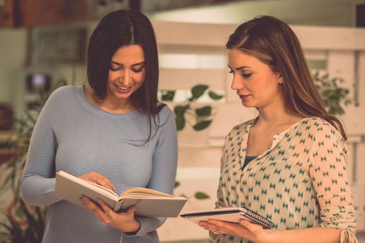 Image of women comparing their notes.