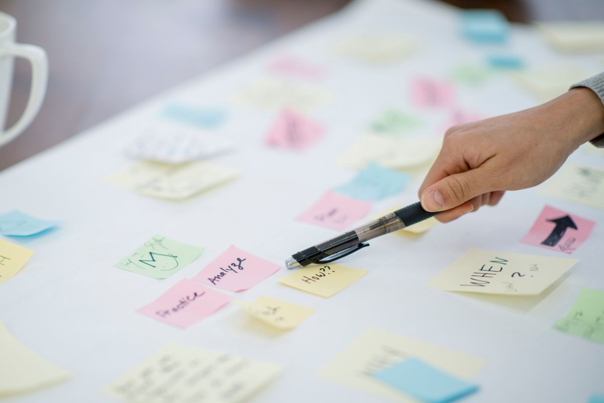  A woman's hand creating a vision board.