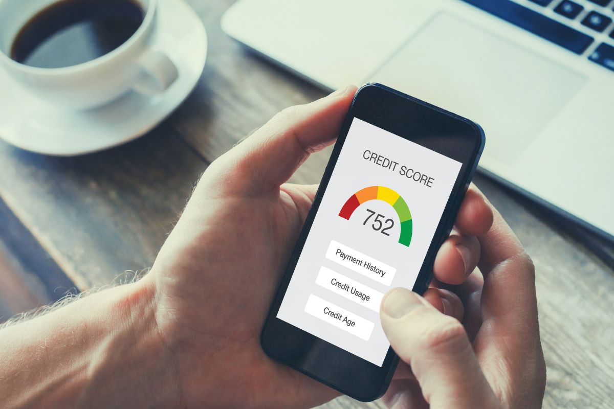 A man's hand checking his credit score.