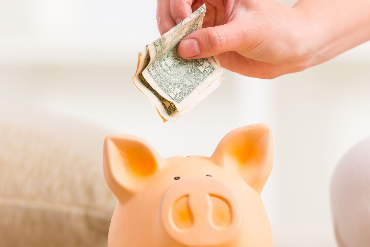 A woman's hand saving money.