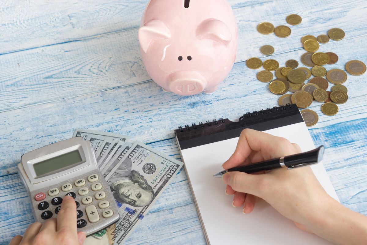 The image shows a woman budgeting money.