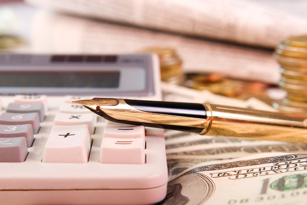 The photo shows money and a calculator.