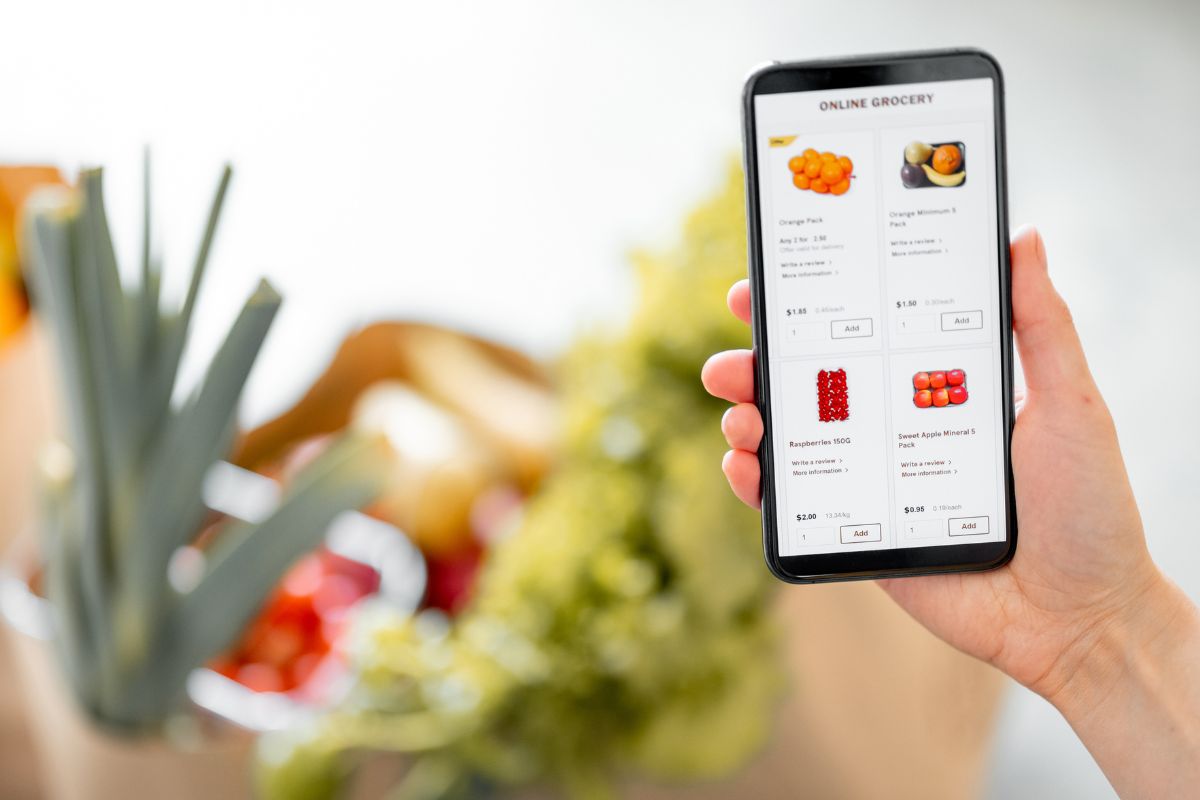 Picture of a woman shopping online for groceries.