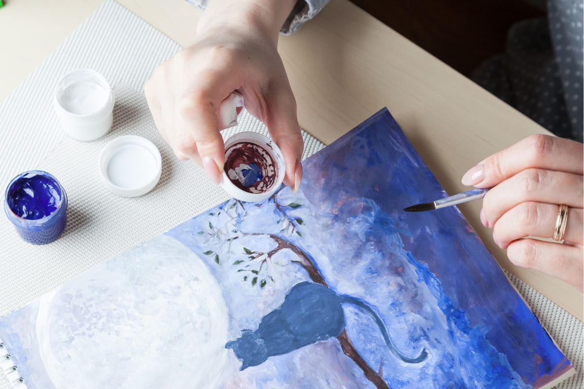 Photo of a woman's hand painting.