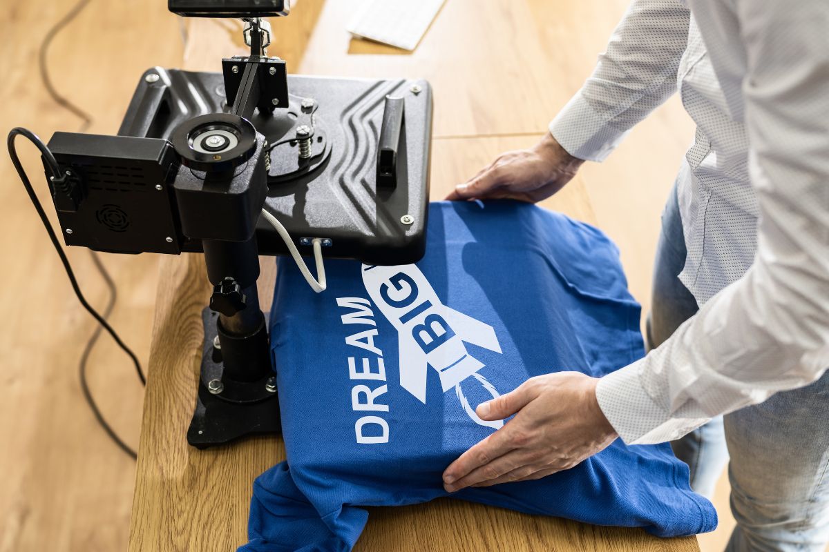 A man printing a shirt.
