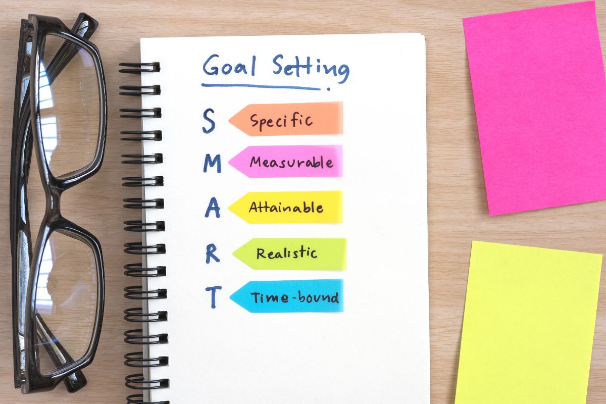 The image shows a notebook with goal setting.