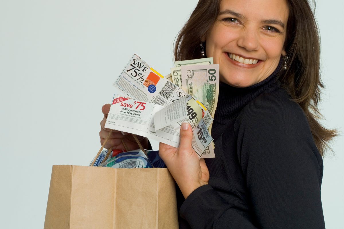 A woman with coupons and a paper bag.