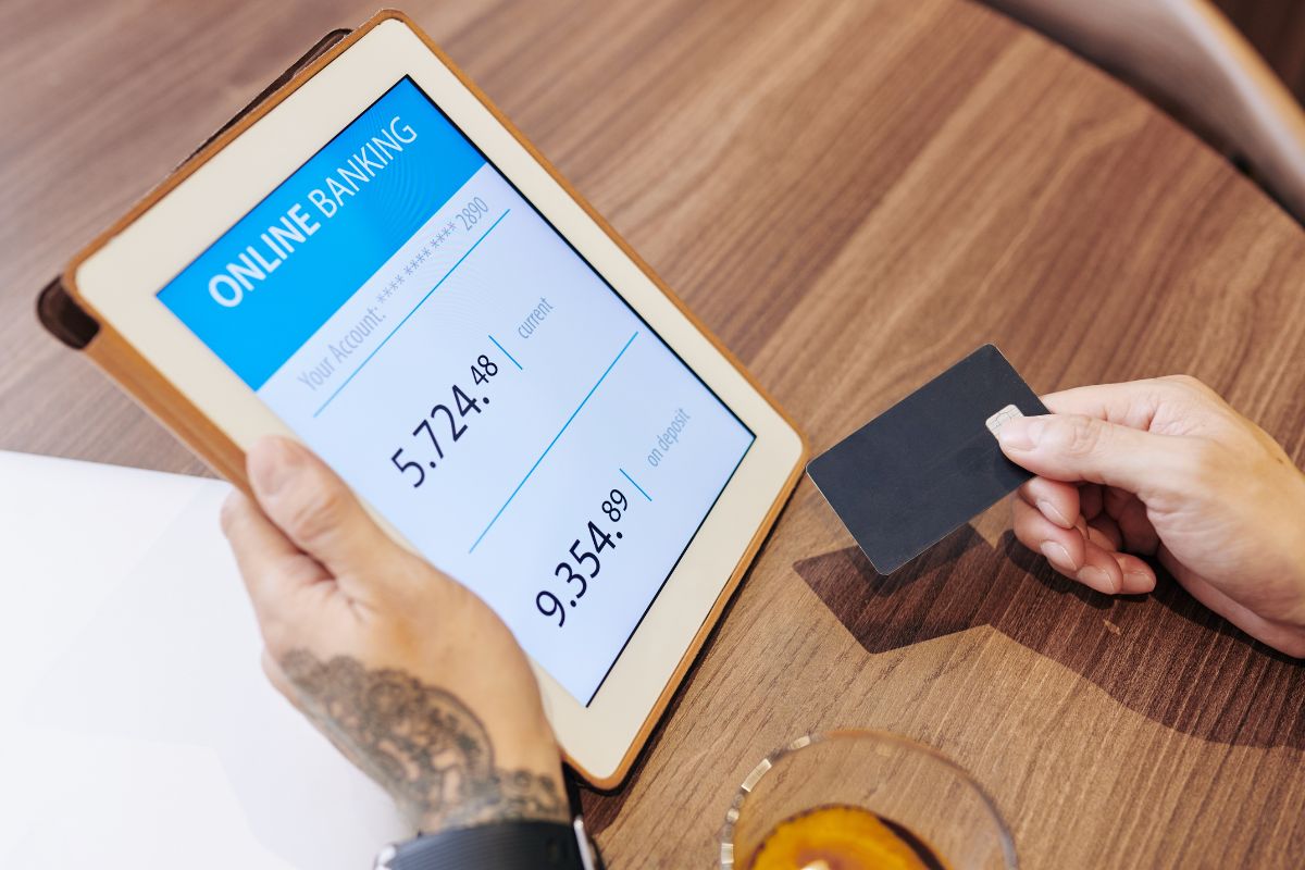 Picture of a man's hand setting up automatic savings.