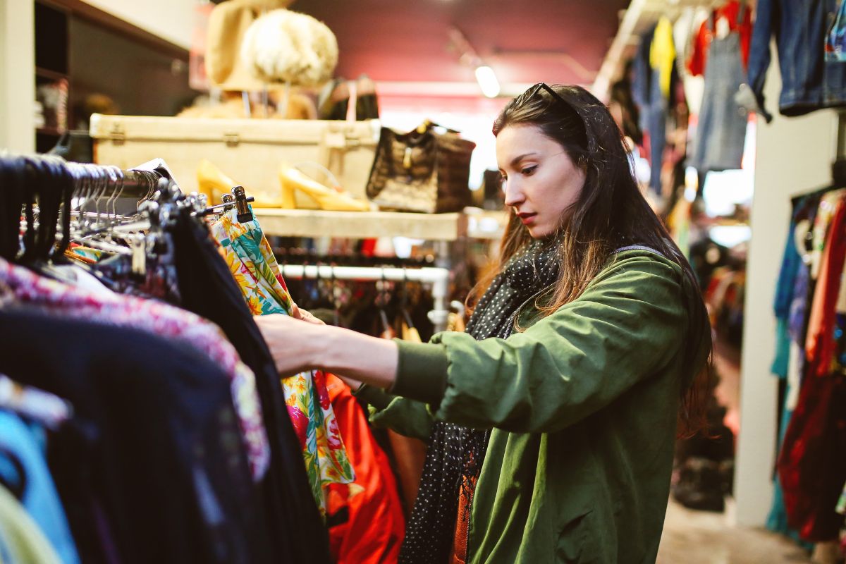 A woman shopping for secondhand clothes.